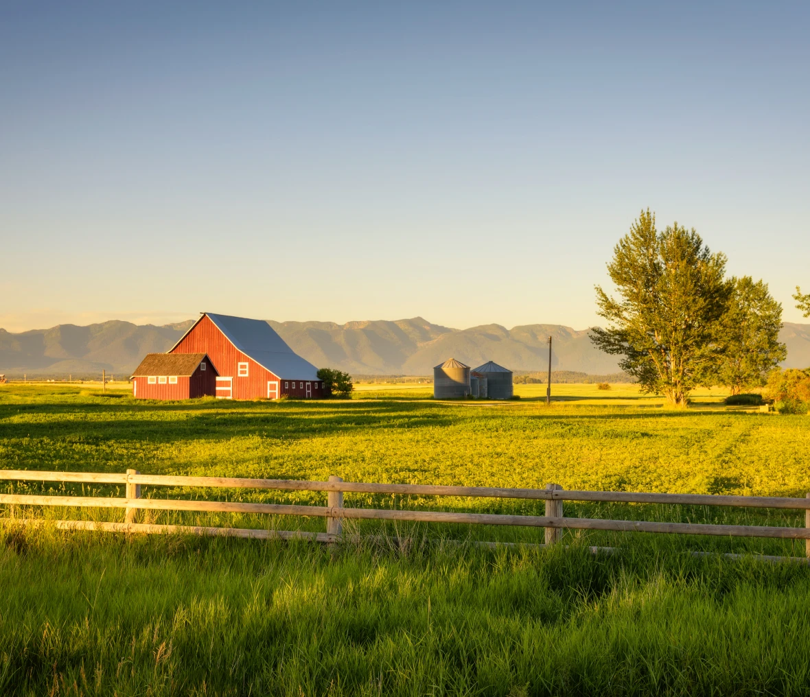 Red barn on sunny rural landscape.